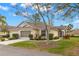 Charming home with a well-manicured lawn, beautiful landscaping, and an attached garage at 2469 Nantucket Harbor Loop # 123, Sun City Center, FL 33573