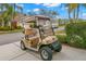 A tan golf cart sits outside of the home at 2469 Nantucket Harbor Loop # 123, Sun City Center, FL 33573