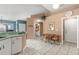 Bright kitchen with white cabinetry, tile flooring, and a breakfast nook featuring a table with seating at 2469 Nantucket Harbor Loop # 123, Sun City Center, FL 33573