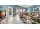 Open living room with neutral paint, tile floors, and plush couches with lots of natural light from the windows at 2469 Nantucket Harbor Loop # 123, Sun City Center, FL 33573