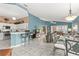 Open living area with tile flooring, kitchen bar, dining space, and comfortable seating arrangement at 2469 Nantucket Harbor Loop # 123, Sun City Center, FL 33573