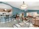Open living space with tile flooring, kitchen bar, dining space, and comfortable seating arrangement at 2469 Nantucket Harbor Loop # 123, Sun City Center, FL 33573