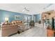 Spacious living room featuring a neutral color palette, ceiling fan, and tile flooring throughout at 2469 Nantucket Harbor Loop # 123, Sun City Center, FL 33573