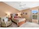 Cozy bedroom showcasing a neutral color scheme, carpet, and large windows with a relaxing sitting area at 2469 Nantucket Harbor Loop # 123, Sun City Center, FL 33573