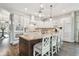 Spacious kitchen featuring white cabinets, a center island with seating, and stainless steel appliances at 32702 Natural Bridge Rd, Wesley Chapel, FL 33543