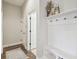 Practical mudroom with a bench, hooks for storage, and doorway leading to another room at 32702 Natural Bridge Rd, Wesley Chapel, FL 33543