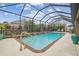 Inviting screened-in pool area with lush landscaping and a relaxing outdoor space at 32702 Natural Bridge Rd, Wesley Chapel, FL 33543