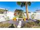 Landscaped sitting area with lush foliage, bench, and potted flowers at 37839 Valencia Ave, Zephyrhills, FL 33541