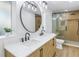 Modern bathroom with a double vanity, large mirror, and glass enclosed shower at 3801 Dr Martin Luther King Jr N St, St Petersburg, FL 33703