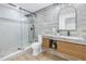 Modern bathroom featuring a glass shower and a vanity with a marble countertop at 3801 Dr Martin Luther King Jr N St, St Petersburg, FL 33703