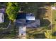 A straight-down aerial view showcases the roof and backyard of the property, surrounded by trees at 38811 Inez Ave, Zephyrhills, FL 33542