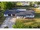 Aerial view of a single-story home with a spacious front yard and attached garage, showcasing its layout at 38811 Inez Ave, Zephyrhills, FL 33542