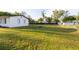 Vast, grassy backyard perfect for outdoor activities, bordered by trees and a chain link fence at 38811 Inez Ave, Zephyrhills, FL 33542