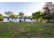 Spacious backyard featuring a fire pit, hammock, and ample space for entertaining or leisure activities at 38811 Inez Ave, Zephyrhills, FL 33542