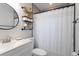 Bright bathroom with modern vanity, mirror, and bathtub with black hardware at 38811 Inez Ave, Zephyrhills, FL 33542
