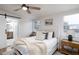 Bright bedroom with a plush bed, stylish linens, and natural light from windows at 38811 Inez Ave, Zephyrhills, FL 33542