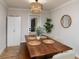 Elegant dining room with a wooden table, modern light fixture, and stylish decor at 38811 Inez Ave, Zephyrhills, FL 33542