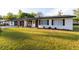 Classic home featuring dark wood shutters and a well-maintained lawn, blending charm with modern appeal at 38811 Inez Ave, Zephyrhills, FL 33542