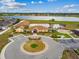 Community clubhouse and pool with lake and play area in view from above at 501 Washita Stone Dr, Ruskin, FL 33570