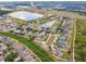 An aerial view of a residential community featuring neighborhood ponds and lush green spaces at 501 Washita Stone Dr, Ruskin, FL 33570