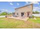 A large backyard is set up with patio, hammock, grill, and lots of green space at 501 Washita Stone Dr, Ruskin, FL 33570