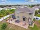 An aerial view of a spacious backyard with a brick patio, a dining set, and a lounge chair at 501 Washita Stone Dr, Ruskin, FL 33570