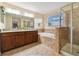 Spacious bathroom with dual vanities, soaking tub, and glass shower at 501 Washita Stone Dr, Ruskin, FL 33570