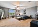 Spacious bedroom features a large window, ceiling fan, and carpet floors at 501 Washita Stone Dr, Ruskin, FL 33570