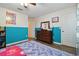 This bright bedroom is finished with blue and white wainscoting and laminate floors at 501 Washita Stone Dr, Ruskin, FL 33570