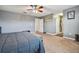Carpeted bedroom featuring a ceiling fan and view of a hallway at 501 Washita Stone Dr, Ruskin, FL 33570