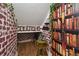 Fun cupboard featuring brick wall, bookshelf wallpaper, and decorations throughout the space at 501 Washita Stone Dr, Ruskin, FL 33570