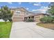 Two-story home with a two-car garage, manicured landscaping and concrete driveway at 501 Washita Stone Dr, Ruskin, FL 33570