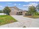 A charming two-story home with a spacious three-car garage and well-manicured landscaping at 501 Washita Stone Dr, Ruskin, FL 33570