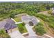 An aerial view of a two-story home with a well-manicured lawn with a two-car garage at 501 Washita Stone Dr, Ruskin, FL 33570