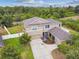 Tan two-story home with a two-car garage, manicured landscaping, and a well-maintained lawn at 501 Washita Stone Dr, Ruskin, FL 33570