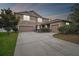 A charming two-story home with a spacious three-car garage and well-manicured landscaping at 501 Washita Stone Dr, Ruskin, FL 33570