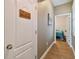 Hallway view leads to bedroom, featuring wood floors and a unique cupboard under the stairs at 501 Washita Stone Dr, Ruskin, FL 33570