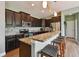 A stylish kitchen with dark wood cabinets, granite countertops, and stainless steel appliances at 501 Washita Stone Dr, Ruskin, FL 33570