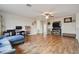 Open living room featuring hardwood floors, ceiling fan, and entertainment center at 501 Washita Stone Dr, Ruskin, FL 33570