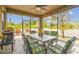 Covered patio with dining set, ceiling fan and outdoor views overlooking the landscape at 501 Washita Stone Dr, Ruskin, FL 33570
