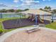 Playground with swings and slides adjacent to picnic seating and the tennis court at 501 Washita Stone Dr, Ruskin, FL 33570