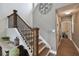 Elegant staircase with dark wood and iron railings leading to the upper level of the home at 501 Washita Stone Dr, Ruskin, FL 33570