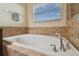 Soaking tub with tile surround and chrome fixtures at 501 Washita Stone Dr, Ruskin, FL 33570