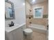 Updated bathroom with a white vanity, toilet, and bathtub with tile surround at 5121 40Th N Ave, St Petersburg, FL 33709