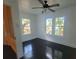 Bedroom featuring hardwood floors, a window, and a ceiling fan at 5121 40Th N Ave, St Petersburg, FL 33709