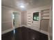 Bedroom with neutral paint, dark wood floors and built-in storage shelves at 5121 40Th N Ave, St Petersburg, FL 33709