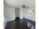 Bedroom featuring hardwood floors, a window, and a ceiling fan at 5121 40Th N Ave, St Petersburg, FL 33709