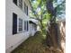 Side of house with black shutters and green space with big trees at 5121 40Th N Ave, St Petersburg, FL 33709