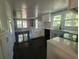 Updated kitchen with white cabinetry, quartz counters, dark floors and stainless steel appliances at 5121 40Th N Ave, St Petersburg, FL 33709