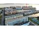 Elevated view of waterfront condos showing parking, docks, tennis courts, and water access at 6025 Shore S Blvd # 611, Gulfport, FL 33707